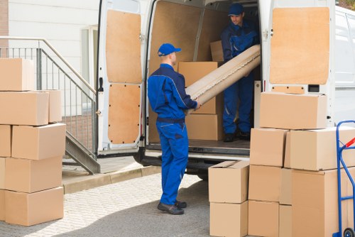 Flat removals team loading boxes in Westminster street