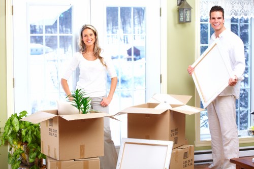 Removal team carrying boxes through a Westminster apartment building